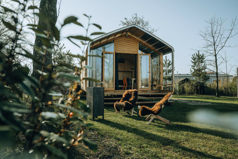 Wikkelhouse Bear, een natuurhuis in vakantiepark De Klepperstee in Nederland met stoelen buiten.