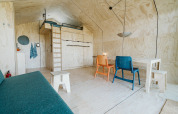 Modern, minimalist interior of Wikkelhouse Bear, a nature house at De Klepperstee park in the Netherlands.