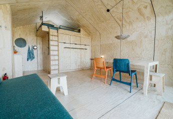 Modern, minimalist interior of Wikkelhouse Bear, a nature house at De Klepperstee park in the Netherlands.