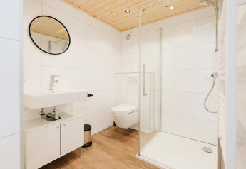 Modern badkamerinterieur in het Stulp tiny house bij De Klepperstee, Nederland, met houten plafond.