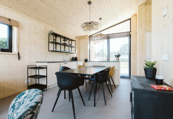 Moderne, lichte eetruimte en keuken in een natuurhuisje op Vakantiepark De Klepperstee, Nederland.