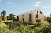 Modern tiny house at Holiday park De Klepperstee in Melle, Netherlands, with wooden exterior and patio.