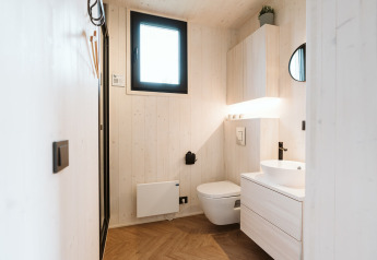 Modern minimalist bathroom in the Tiny Rebel tiny house at Holiday park De Klepperstee, Netherlands.