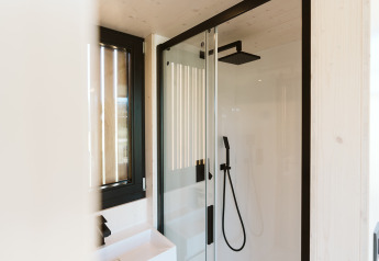Moderne douche en raam in het tiny house Backer op Holiday park De Klepperstee, Nederland.