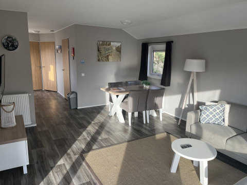 Modern Velthorst lodge interior at Poort van Zeeland, Netherlands, featuring dining and living areas.