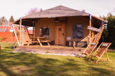 Safari-telt Cottage ved Camping Vossenberg, Holland, med trædæk og havemøbler i fredelig have.
