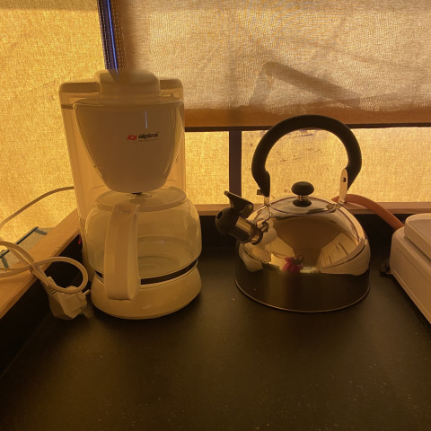 Cafetera y tetera en la encimera de una tienda safari en Holiday Park Duinhoeve, Países Bajos, al amanecer.