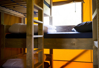 Interiør af safaritelten Glamping Deluxe type 1 med køjesenge i Holiday Park Duinhoeve, Holland.