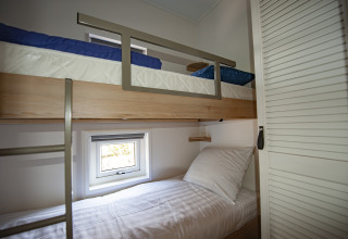 Modern bunk beds in a cozy room at Dune Lodge Family, Camping Zonneweelde, Netherlands, minimalist style.