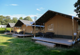 Safari tents on wooden decks at Recreation Park and Marina Rhederlaagse Meren in the Netherlands, sunny day.