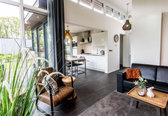 Modern Z Module lodge at Landgoed de Scheleberg in the Netherlands, featuring stylish interior and large windows.