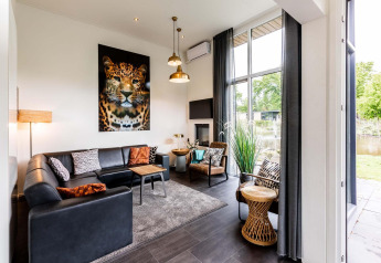 Salón moderno en Z Module, Landgoed de Scheleberg, Países Bajos, con arte de leopardo y grandes ventanales.