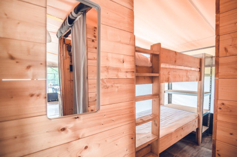 Houten interieur en stapelbedden in een Tentvilla safari tent op Vakantiepark Ackersate, Nederland.
