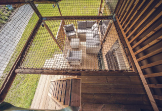 Bovenaanzicht van zit- en terrasruimte bij safaritent 'Red Deer' in Vakantiepark Ackersate in Nederland.
