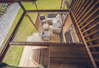 Top-down view of seating area and wooden deck at Safari tent 'Red Deer' in Holiday park Ackersate, Netherlands.