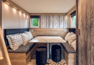 Zona de comedor en una tiny house del Holiday park Ackersate, Países Bajos, con decoración moderna y luminosa.