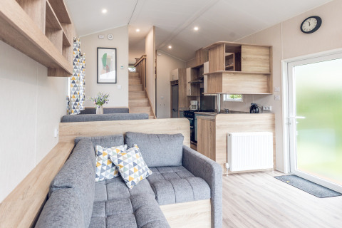 Modern, compact living room and kitchen in a tiny house at Holiday park Ackersate, Netherlands.