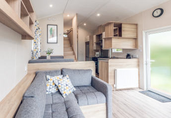 Modern, compact living room and kitchen in a tiny house at Holiday park Ackersate, Netherlands.