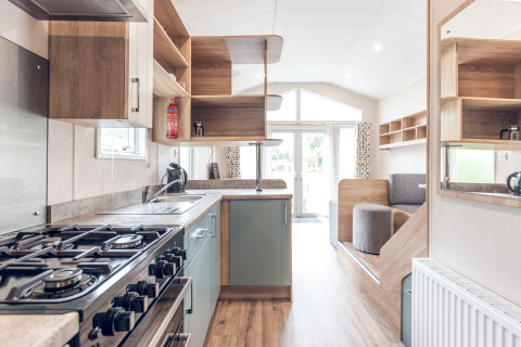 Bright modern kitchen and living space inside a tiny house lodge at Holiday park Ackersate, Netherlands.