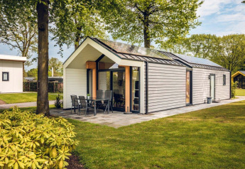 The eco-friendly Ecovilla lodge at Holiday Park Ackersate in the Netherlands, surrounded by green trees.