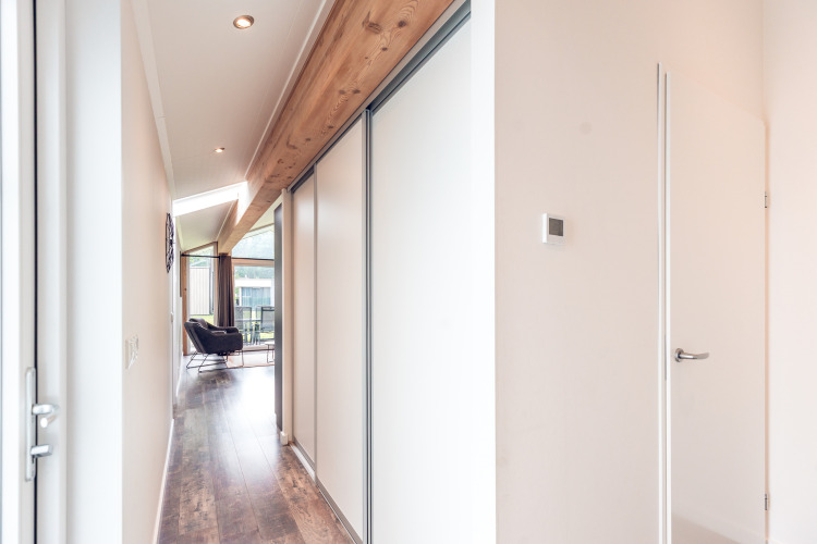 Bright hallway in Ecovilla at Holiday park Ackersate, Netherlands, with wooden accents and modern furnishings.