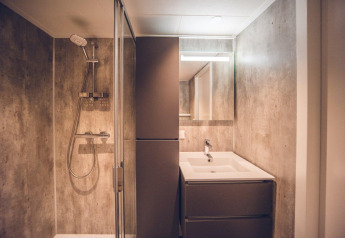 Modern bathroom with shower and sink at Hunting chalet in Holiday park Ackersate, Netherlands.
