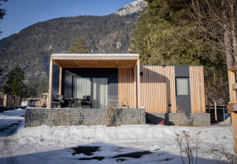 Chalet moderne de Wulfenia au Pressegger See, Autriche, en hiver avec montagnes enneigées au fond.