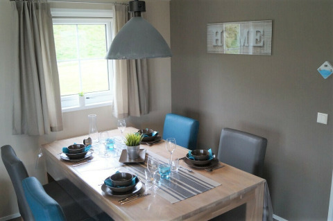 Eethoek van Chalet Marron bij Camping & Ferienpark Brilon, Duitsland, modern gedekte tafel.