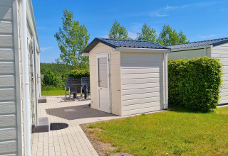 Bright, sunny chalet area with terrace and shed at Camping & Ferienpark Brilon, Germany.