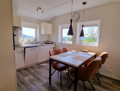 Cocina moderna y comedor en Chalet Limonet, Camping & Ferienpark Brilon, con grandes ventanas y vistoso paisaje.