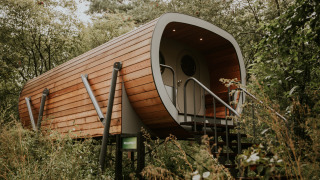 Skycabin nature house at Camping Si-Es-An in the Netherlands, modern wooden cabin surrounded by trees.