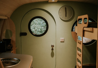 Interior of Skycabin at Camping Si-Es-An, Netherlands, featuring round windows and modern bunk beds.