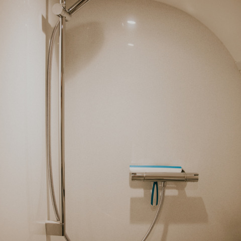 Modern shower in a minimalist bathroom at Skycabin, Nature house, Camping Si-Es-An, Netherlands.