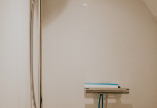 Modern shower in a minimalist bathroom at Skycabin, Nature house, Camping Si-Es-An, Netherlands.