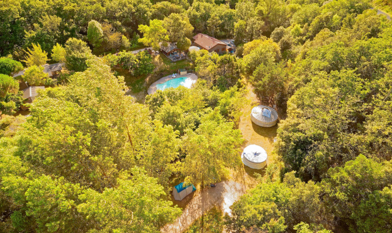 Vista aérea de XL Yurt Tent sin baño privado en Camping Des Randonneurs, rodeada de naturaleza y árboles.