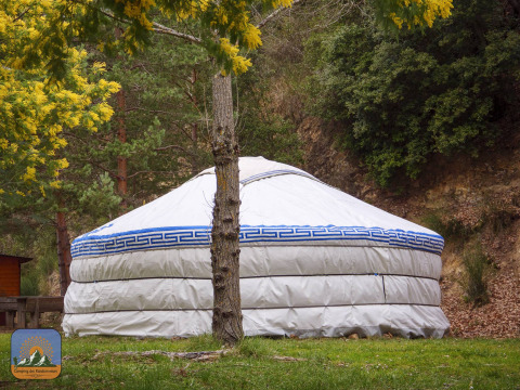 Tienda yurta XL sin baño privado en Camping Des Randonneurs, Francia, rodeada de naturaleza y árboles.