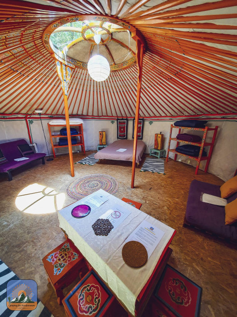 Interior of the XL Yurt Tent without a private bathroom at Camping Des Randonneurs in France.