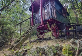 Gypsy-vognhytte uden privat badeværelse på Camping Des Randonneurs i Frankrig, omgivet af skov.