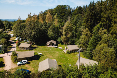 Luftaufnahme des Safari-Zelts Villatent Wood auf Camping Au Clos de La Chaume, umgeben von Wald in Frankreich.