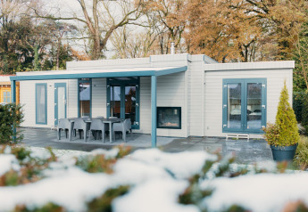 Modern Veluwe Villa at Holiday park De Boshoek in the Netherlands with terrace and outdoor dining area.