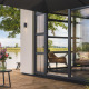 View of a cozy deck at Villa Maritiem in MarinaPark Bad Nederrijn, Netherlands, by the riverside with greenery.