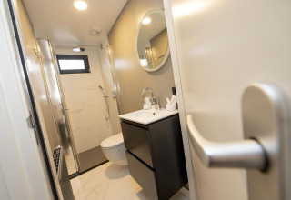 Baño moderno en Houseboat Offingawier en Welcome In - Friesland con ducha, inodoro y lavabo en Países Bajos.