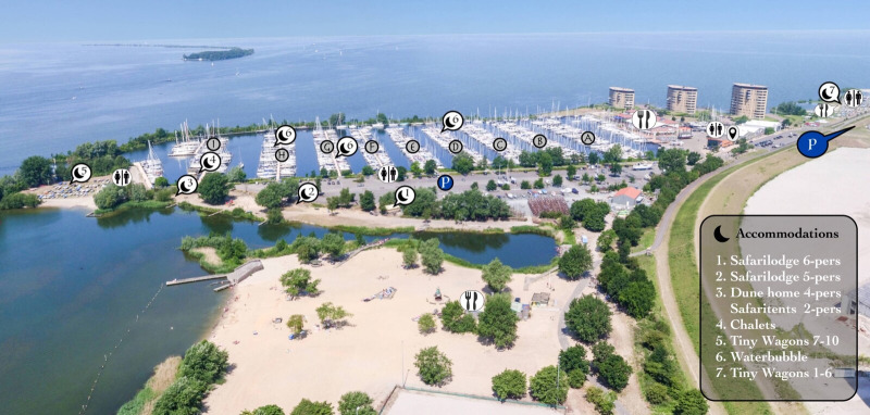 Aerial view of Marina Parcs Almere in the Netherlands, showing beach, tiny houses, and water bubbles.