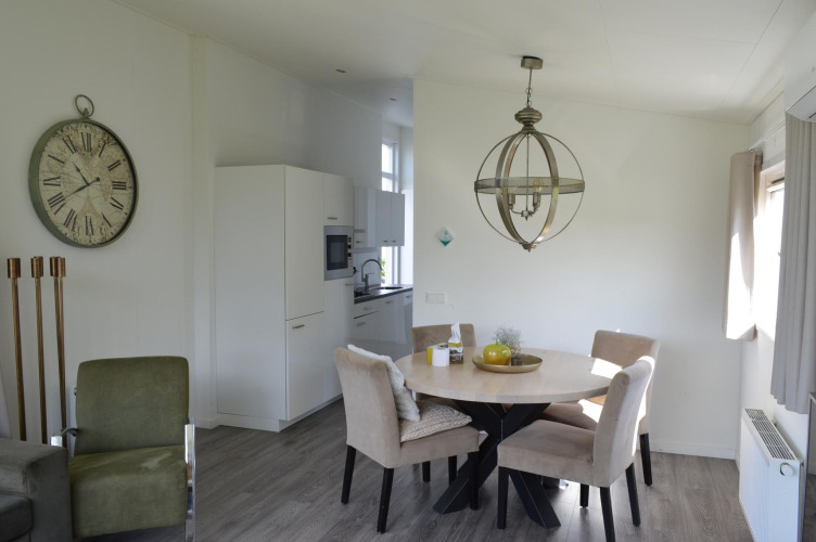 Bright dining area and kitchen at Biebosch - Sunshower lodge, Resort Mooi Bemelen, Netherlands.
