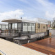 Modern houseboat with roof terrace docked at a marina in Offingawier, Friesland, Netherlands.