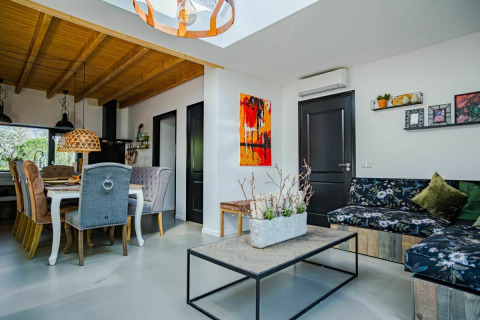 Stylish interior at Nature House, Buitengoed Ruysbos, Netherlands, featuring dining area and cozy living space.