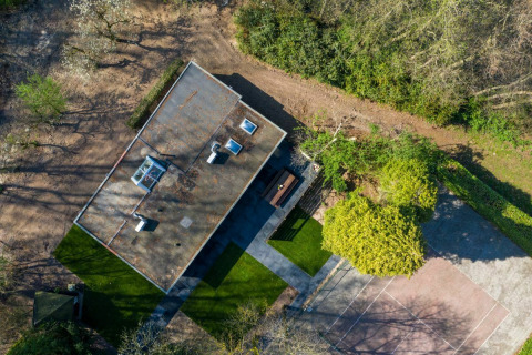 Luchtfoto van Nature House lodge bij Buitengoed Ruysbos in Nederland, omgeven door bomen en paden.