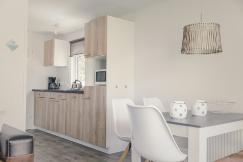Moderne køkken og spiseområde i en lodge på 6x bungalette ved Holiday Park Mölke, Holland, med trædetaljer.