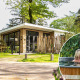 Modern Silva Wellness lodge at Bospark Ede, Netherlands, with hot tub and couple enjoying the outdoor spa.