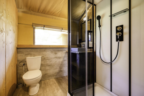 Modern bathroom with shower, toilet and sink inside Stardust 40 Family Lodge at Arden Parks, Signy l'Abbaye.